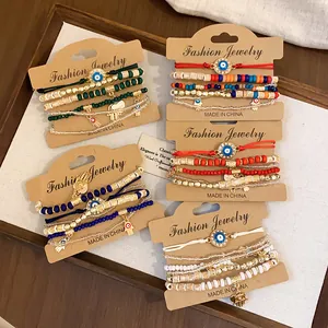 Detailed view of multi-layered beaded bracelet sets with evil eye and hamsa hand charms