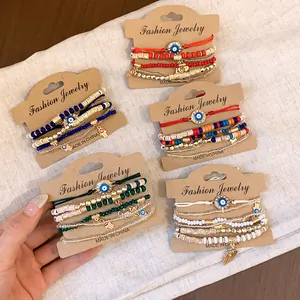 Close-up of five evil eye beaded elastic bracelet sets featuring hamsa charms and vibrant beads