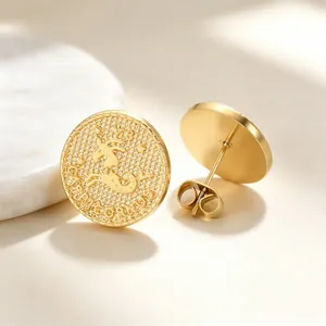 Close-up of gold-plated Capricorn zodiac coin stud earrings made of stainless steel
