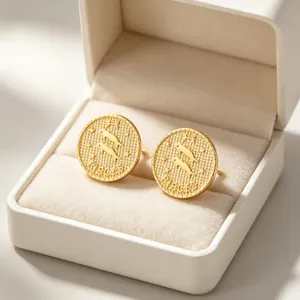 Detailed close-up of vintage gold Pisces constellation coin stud earrings in a box.