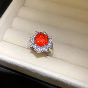 Detailansicht eines silbernen Blumenrings mit strahlendem orangefarbenem Zirkon.