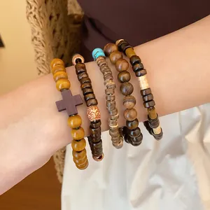 Detail view of five-piece Bohemian wooden beaded bracelet set worn on wrist