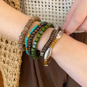 Close-up of bohemian beaded bracelet set featuring wood and turquoise style beads
