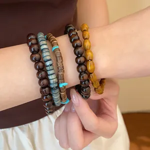 Detail view of a bohemian beaded bracelet set featuring natural wood and turquoise accents