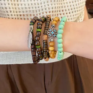 Detail shot of bohemian beaded bracelets set featuring wood beads and charms