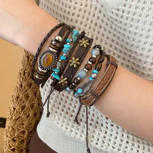 Detailed view of bohemian layered bracelets with turquoise and leather on wrist.