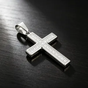 Macro detail of polished stainless steel cross pendant with sparkling iced-out stones