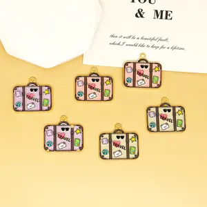 Macro view of six pastel enamel suitcase charms showing printed travel icons and details