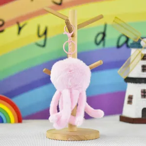 Close-up detail view of a soft pink plush jellyfish keychain showing fine fur texture