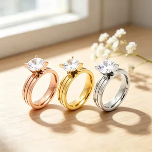 Detail view of three stainless steel rings with cz stones in gold, silver, and rose gold.