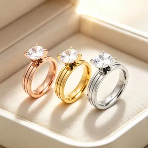 Close-up of triple-band stainless steel rings with round cubic zirconia settings