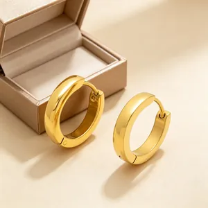Macro view of minimalist round gold stainless steel hoop earrings with polished finish