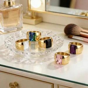 Close-up detail of colorful titanium steel wide rings with vibrant glass gemstones.