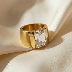Close-up of elegant gold-finished titanium steel ring with a large rectangular stone