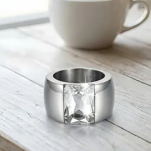 Detail macro view of a stylish wide titanium steel ring featuring a large clear stone
