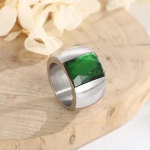 High-end titanium steel wide band ring featuring a large faceted emerald green glass stone