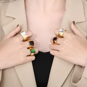 Detailed macro shot of elegant gold titanium steel rings with colorful glass stones