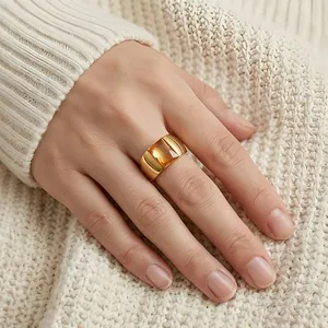 Elegant wide golden titanium steel ring featuring a large rectangular amber glass gemstone on a hand