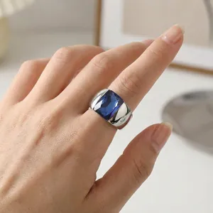 Detailed shot of a silver titanium steel ring with a large blue rectangular glass gem
