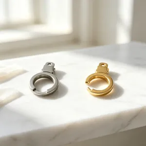 Detailed view of silver and gold stainless steel handcuff-style clasps on marble