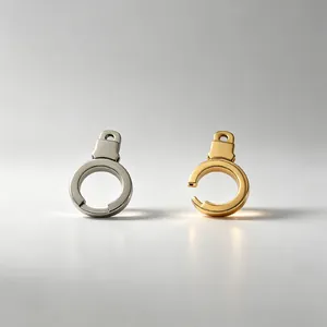 Detail view of gold and silver stainless steel handcuff-shaped charms for keychains
