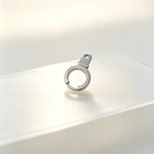 Detailed macro view of a rotatable stainless steel handcuff-shaped spring clasp.