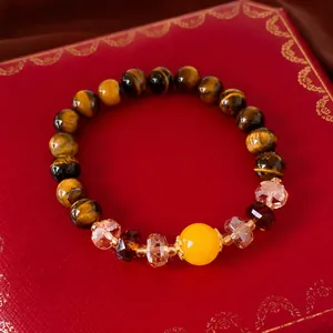 Exquisite tiger eye beaded bracelet featuring a yellow center stone and faceted crystals