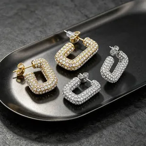 Detailed view of full pavé rhinestone oval stainless steel hoop earrings in gold and silver.