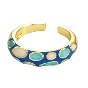 Macro view of a colorful enamel open ring with intricate Cloisonné patterns and gold finish