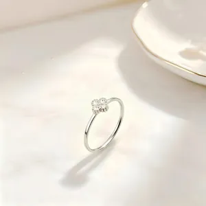 Macro view of a silver-tone clover ring with four sparkling inlaid stones