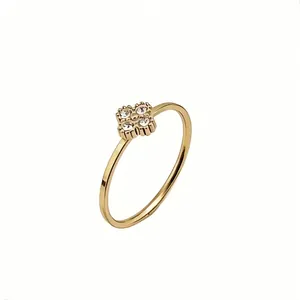 Detailed view of a gold titanium steel ring featuring a crystal-set flower motif