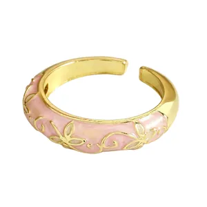 Detail shot of a pink enamel flower ring in gold-plated cloisonne style