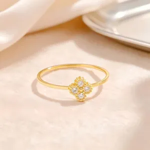 Detailed view of gold-plated titanium steel ring with sparkling four-leaf clover motif