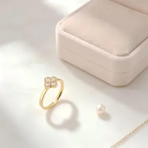Close-up of a gold titanium steel ring featuring a four-leaf clover set with sparkling stones.
