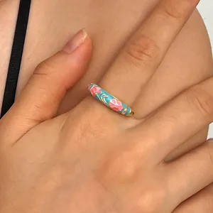 Elegant cloisonné enamel ring featuring delicate pink flowers on a sky blue band
