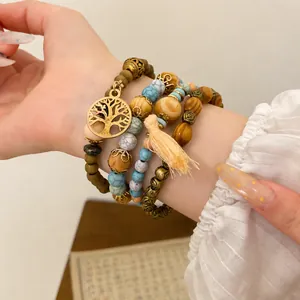 Vintage Bohemian 4er-Set elastische Armbänder mit Holzperlen und Lebensbaum-Anhänger