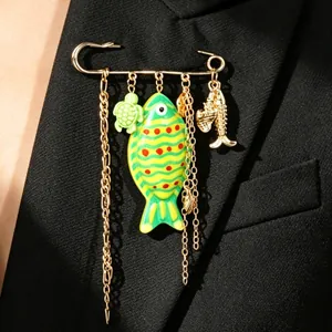 Detailed view of ocean-themed brooch with green fish and turtle charms on black blazer