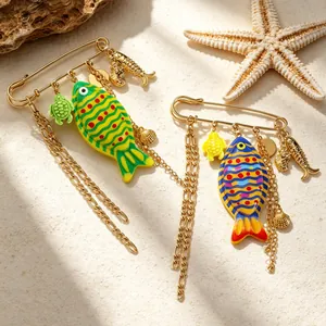 Detailed view of colorful ocean-themed safety pin brooches with fish and turtle charms