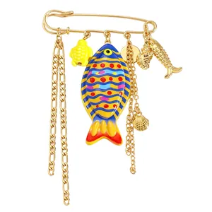 Detailed view of ocean-themed safety pin brooch with colorful fish and sea turtle charms