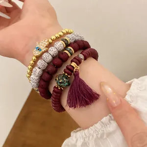 Bohemian beaded bracelet set featuring Hamsa Hand and tassel charms on model's wrist