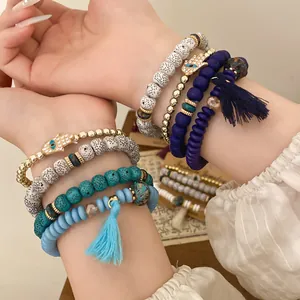 Detailed view of Bohemian beaded bracelet sets with hamsa hand charms and colorful tassels