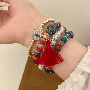 Bohemian acrylic bead bracelet set with Hamsa hand charm and red tassel detail