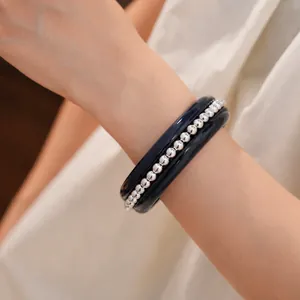 Elegant minimalist navy resin bangle set with silver-tone beaded bracelet on wrist