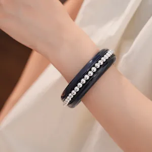 Detail view of a minimalist resin bracelet inlaid with elegant silver beads on a wrist