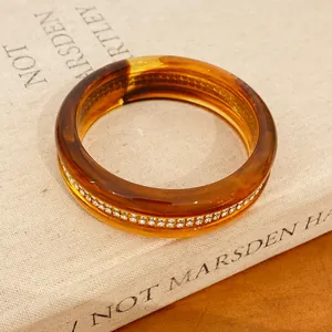 Macro view of a luxury vintage resin tortoise shell bangle with sparkling rhinestone detail