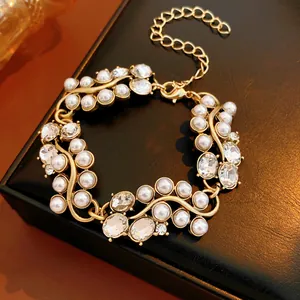 Detailed macro shot of an elegant gold flower bracelet with pearls and sparkling zircons