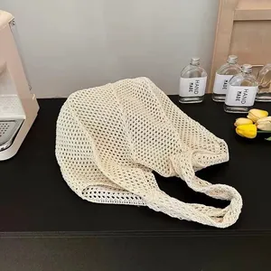 Macro detail of cream white knitted mesh tote bag with large capacity for beach travel