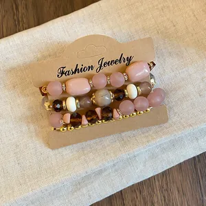 Detail of Bohemian beaded bracelet set with pink and brown acrylic beads.
