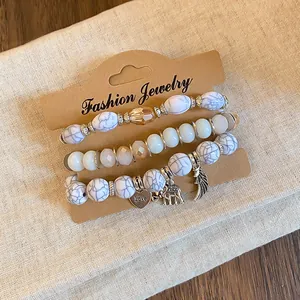 Detailed view of Bohemian three-piece bracelet set with marble beads and silver charms
