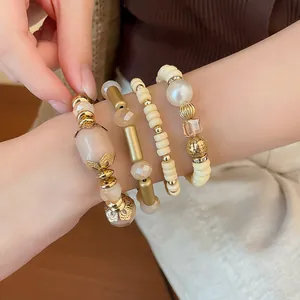 Detailed macro view of a bohemian style beaded bracelet set with acrylic and gold accents